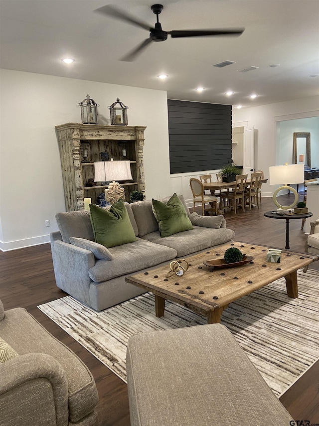 living room with ceiling fan and dark hardwood / wood-style floors