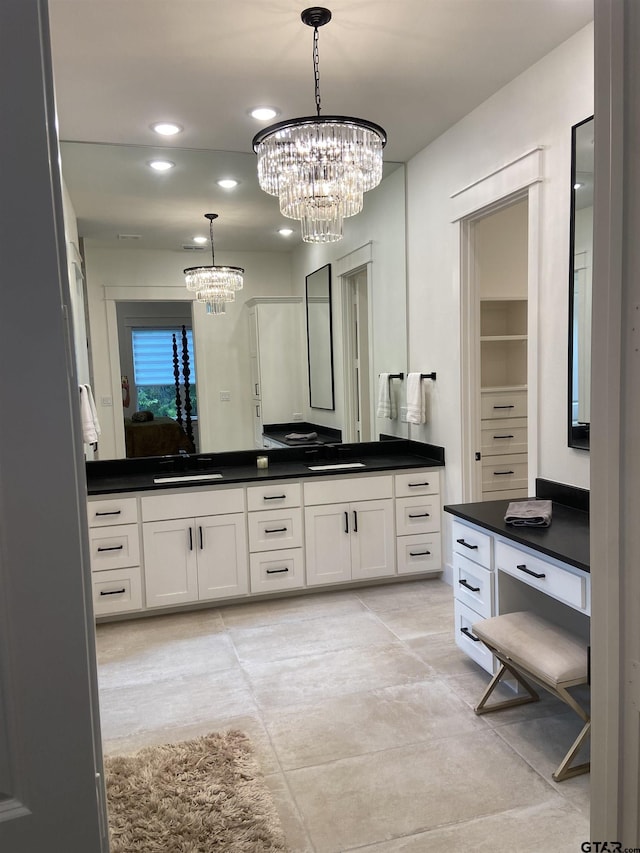 bathroom featuring a chandelier and vanity