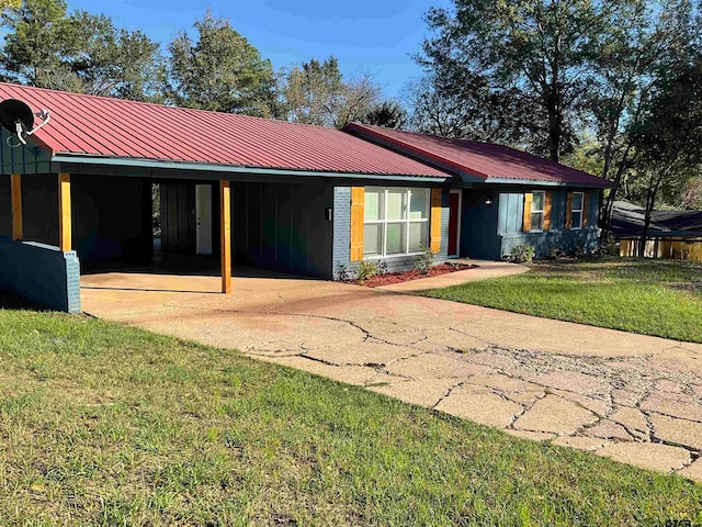 rear view of property featuring a yard and a carport