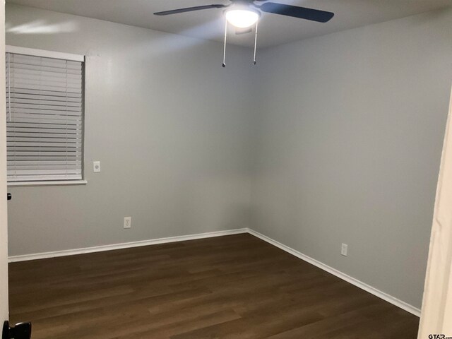 spare room with ceiling fan and dark hardwood / wood-style floors