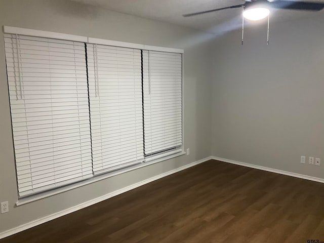 spare room featuring dark hardwood / wood-style flooring and ceiling fan