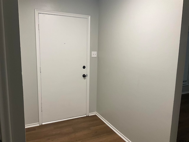 doorway with dark wood-type flooring