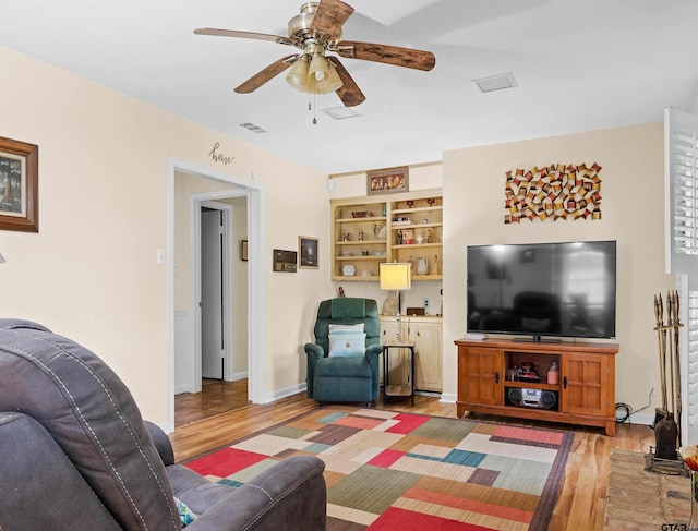 living room with hardwood / wood-style flooring and ceiling fan