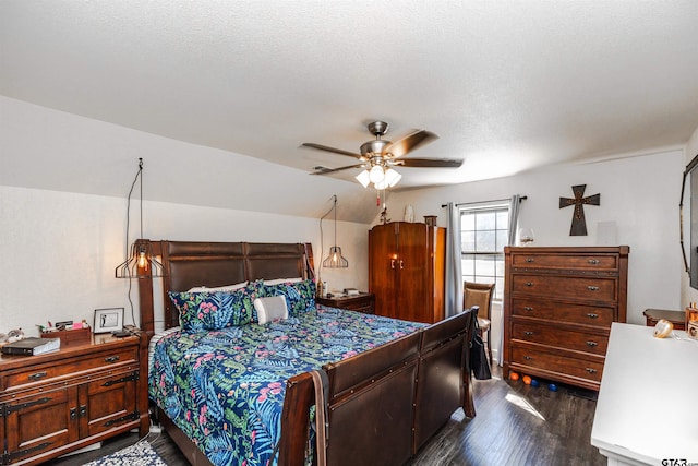 bedroom with ceiling fan, dark hardwood / wood-style floors, and a textured ceiling