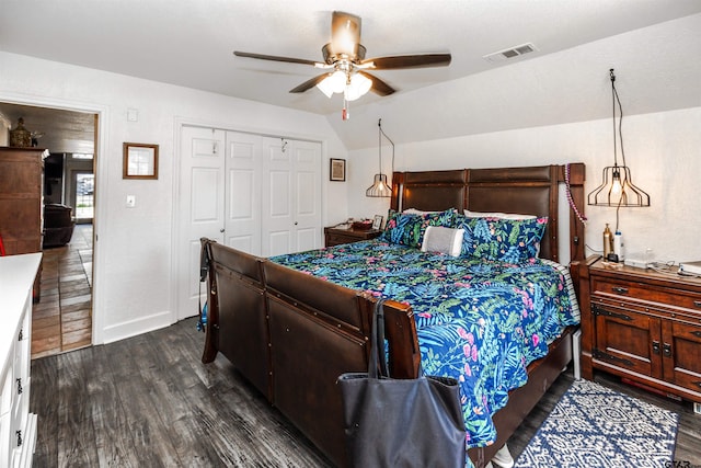 bedroom with ceiling fan, a closet, dark hardwood / wood-style flooring, and vaulted ceiling