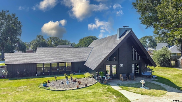 rear view of house featuring a yard, french doors, and a patio