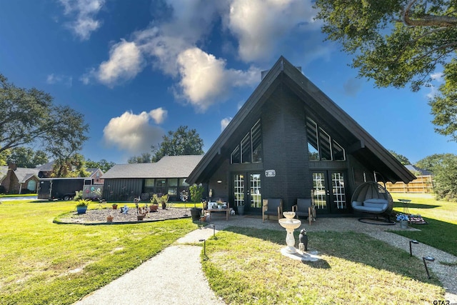 view of front of house with a front lawn and french doors