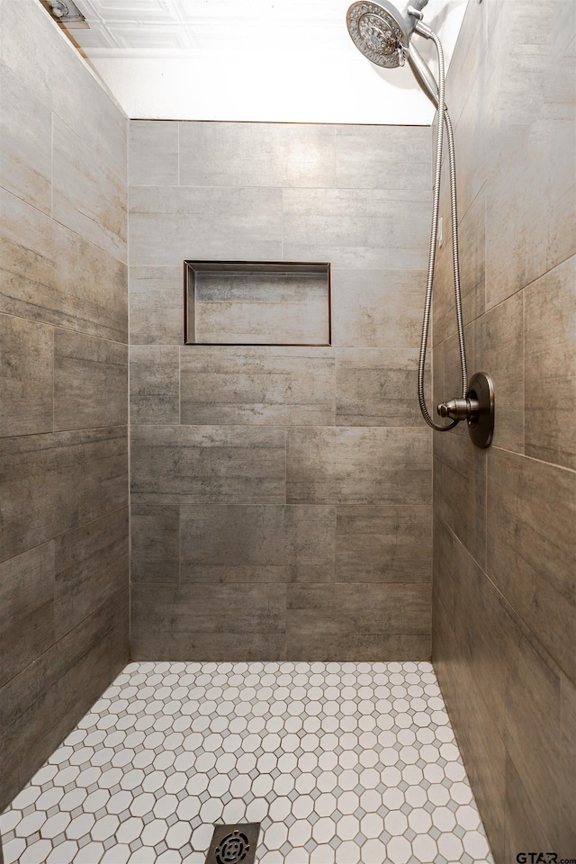 bathroom with a tile shower