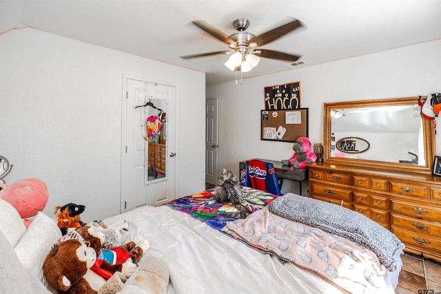 bedroom with ceiling fan and a closet