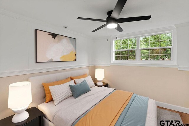 2442 E Devine, Tyler, TX 75701 - bedroom featuring multiple windows, crown molding, ceiling fan, and wood finished floors