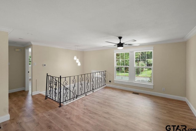 2442 E Devine, Tyler, TX 75701 - empty room with crown molding, wood finished floors, baseboards, and a ceiling fan