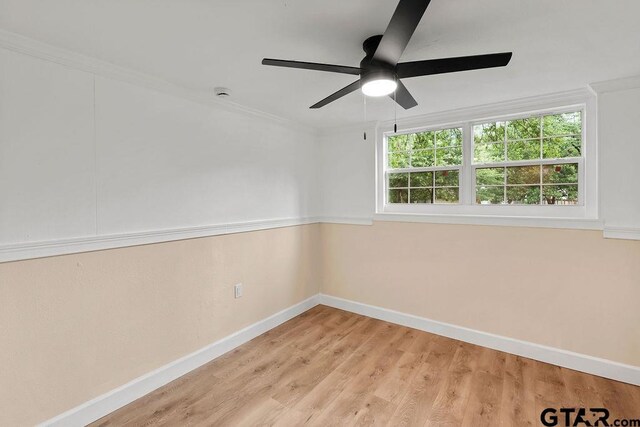 2442 E Devine, Tyler, TX 75701 - spare room featuring baseboards, healthy amount of natural light, ceiling fan, light wood-type flooring, and ornamental molding