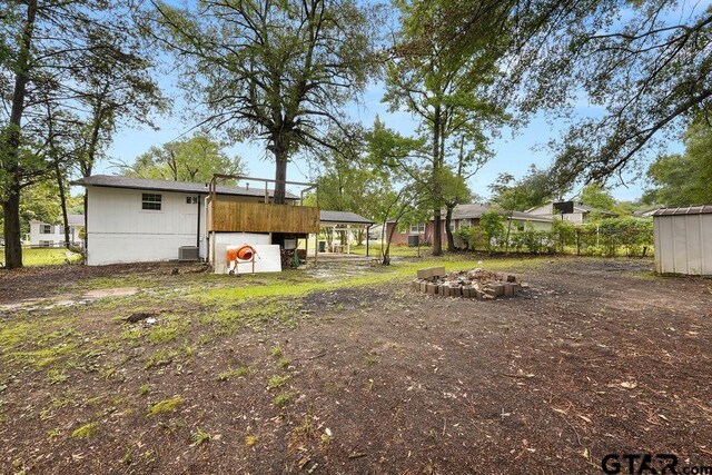 2442 E Devine, Tyler, TX 75701 - view of yard featuring an outdoor structure and central AC unit