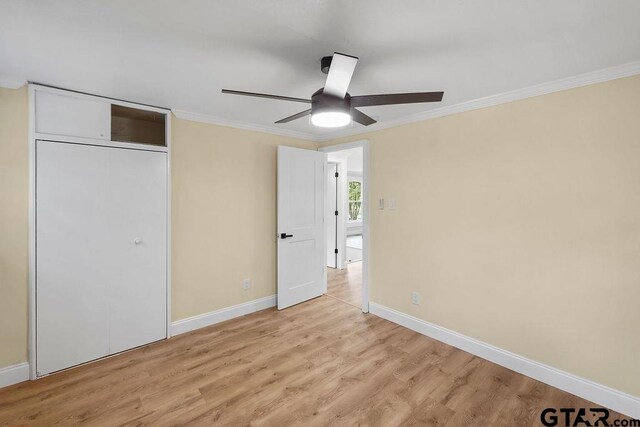2442 E Devine, Tyler, TX 75701 - unfurnished bedroom with ornamental molding, light wood-style floors, baseboards, and ceiling fan