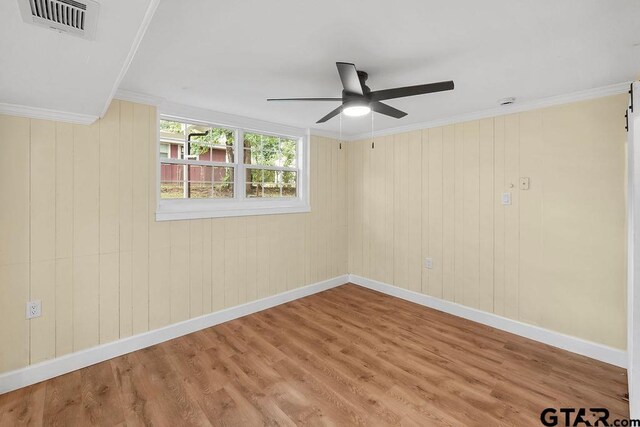 2442 E Devine, Tyler, TX 75701 - spare room with a ceiling fan, baseboards, wood finished floors, and ornamental molding