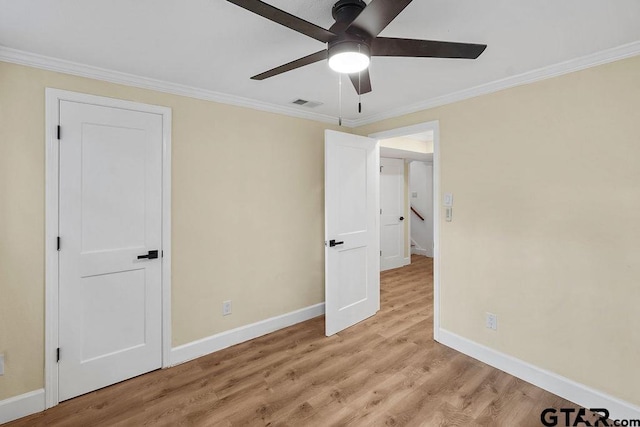 2442 E Devine, Tyler, TX 75701 - unfurnished bedroom featuring baseboards, light wood-style flooring, ornamental molding, and a ceiling fan