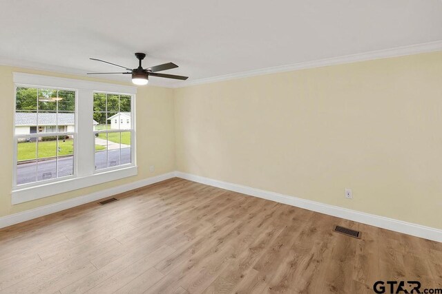 2442 E Devine, Tyler, TX 75701 - unfurnished room featuring baseboards, crown molding, light wood-style floors, and a ceiling fan