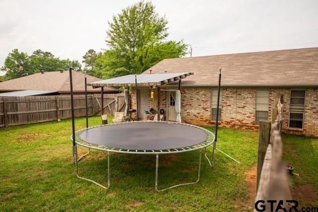 304 Blake Dr, Longview, TX 75604 - fenced backyard featuring a trampoline