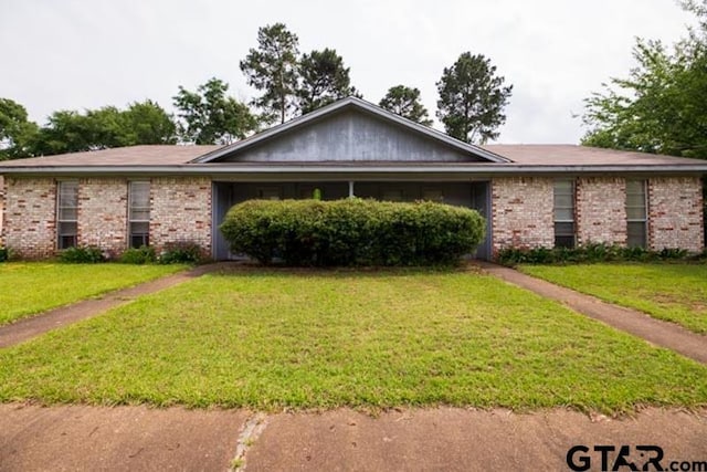 304 Blake Dr, Longview, TX 75604 - ranch-style house featuring a front yard and brick siding