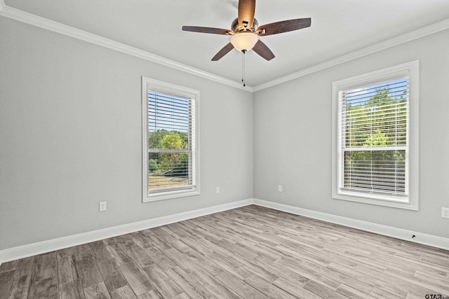 spare room featuring crown molding and light hardwood / wood-style flooring