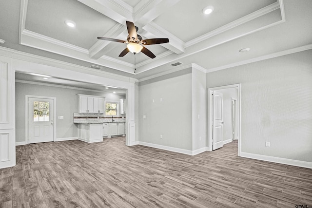 unfurnished living room with beamed ceiling, light wood-type flooring, and crown molding