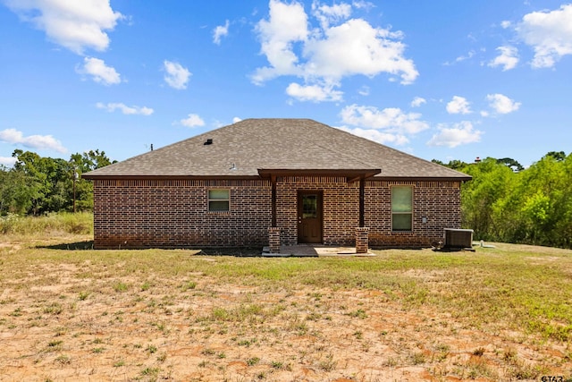 back of house featuring central air condition unit, a patio area, and a yard