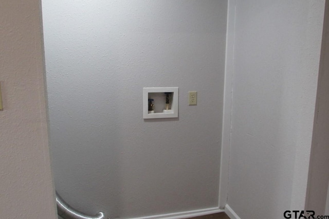 clothes washing area featuring hookup for a washing machine, laundry area, and baseboards