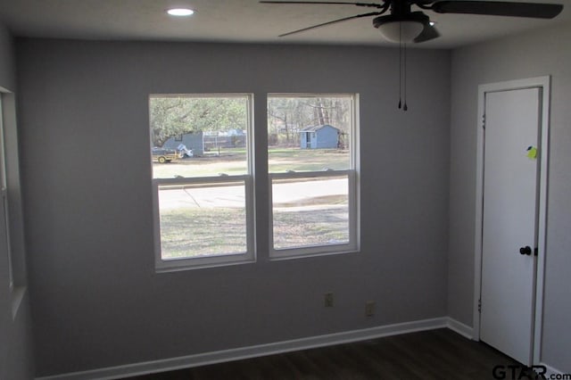 spare room featuring dark wood-style floors, recessed lighting, a ceiling fan, and baseboards