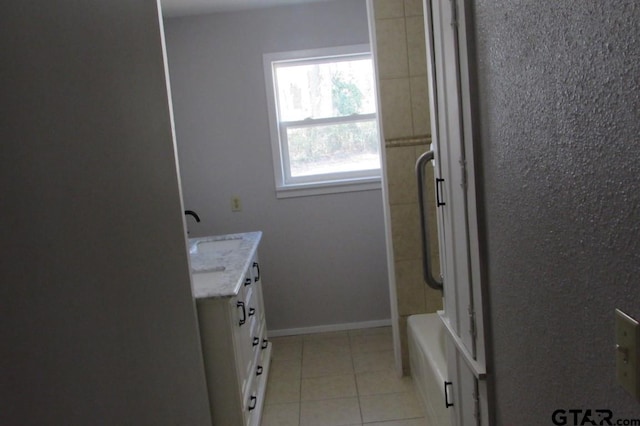 bathroom with tile patterned flooring, vanity, and baseboards