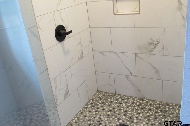 bathroom with tiled shower