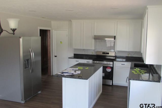 kitchen featuring white cabinets, under cabinet range hood, stainless steel appliances, and a center island