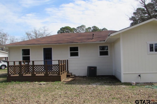 back of house featuring central AC and a yard