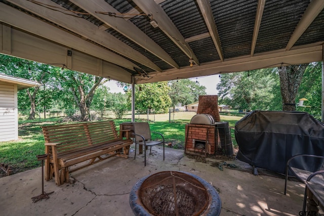 126 Jordan, Rusk, TX 75785 - view of patio / terrace featuring an outdoor brick fireplace, a grill, and a fire pit