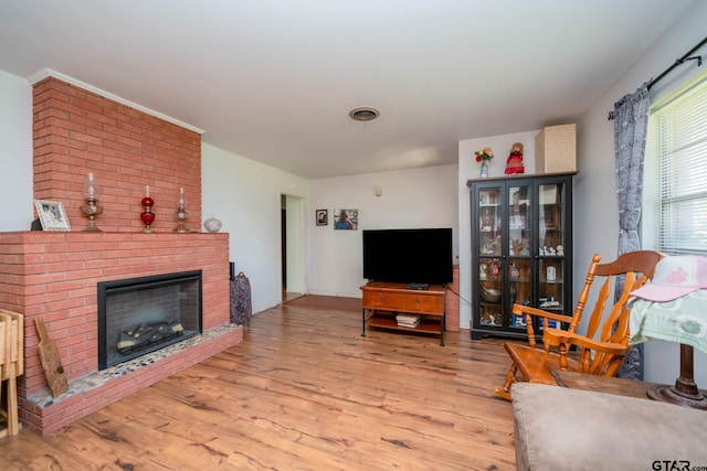 126 Jordan, Rusk, TX 75785 - living area featuring wood finished floors and a brick fireplace