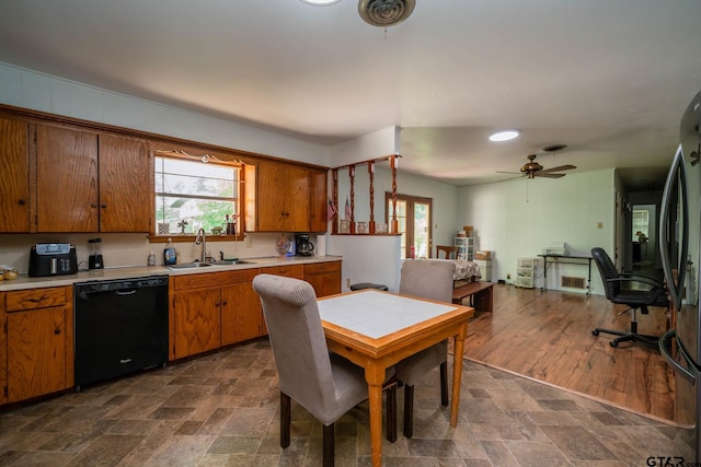 126 Jordan, Rusk, TX 75785 - kitchen with dishwasher, light countertops, brown cabinets, and plenty of natural light