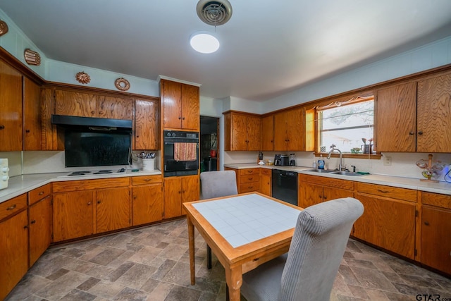 126 Jordan, Rusk, TX 75785 - kitchen with black appliances, stone finish flooring, light countertops, and brown cabinets