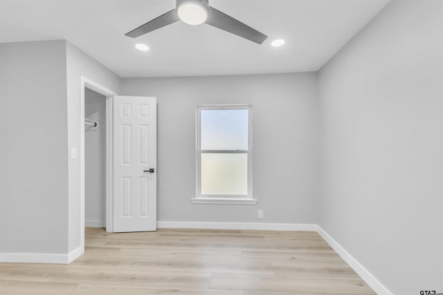 unfurnished room with light wood-type flooring, baseboards, and recessed lighting