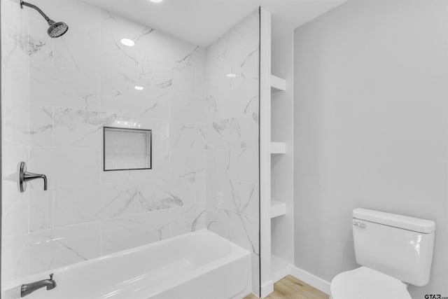 full bathroom with shower / bathtub combination, wood finished floors, toilet, and baseboards