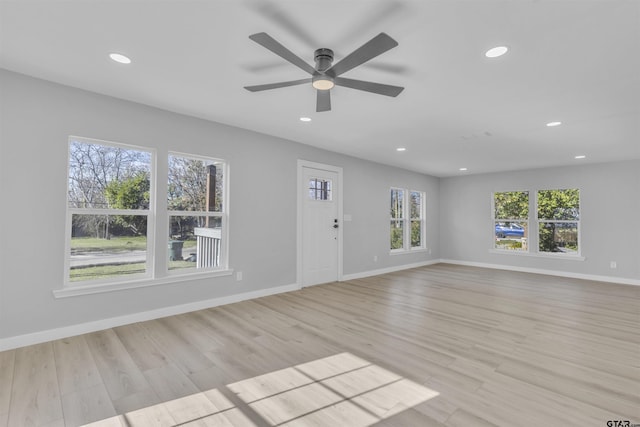 unfurnished living room with ceiling fan, recessed lighting, light wood-style flooring, and baseboards