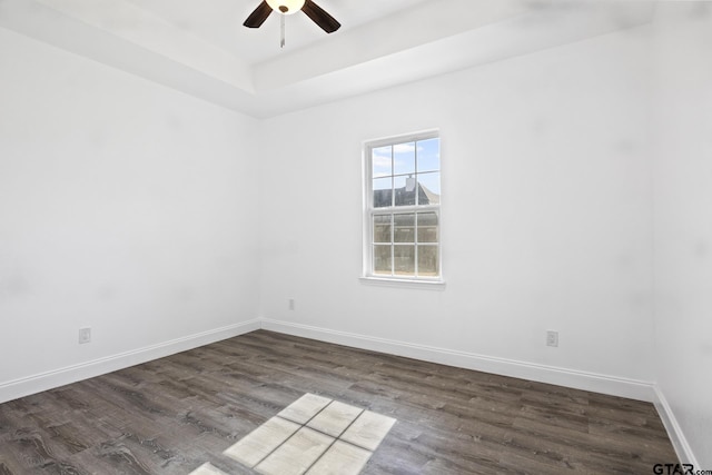 empty room with ceiling fan and dark hardwood / wood-style flooring