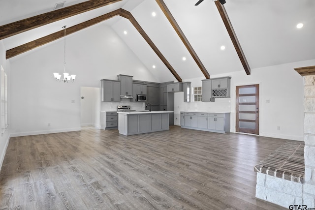 kitchen with gray cabinetry, beamed ceiling, high vaulted ceiling, and hardwood / wood-style flooring