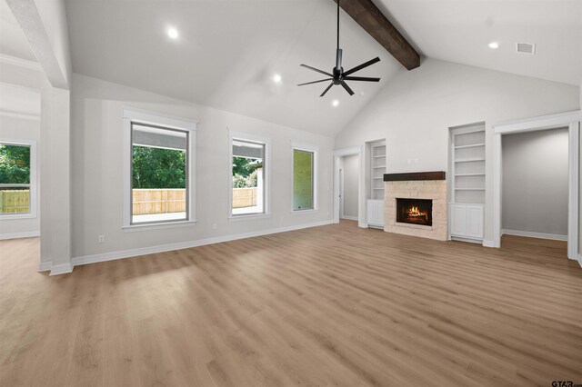 1838 Rocky Mtn, Tyler, TX 75703 - unfurnished living room with recessed lighting, ceiling fan, beamed ceiling, built in features, and a stone fireplace