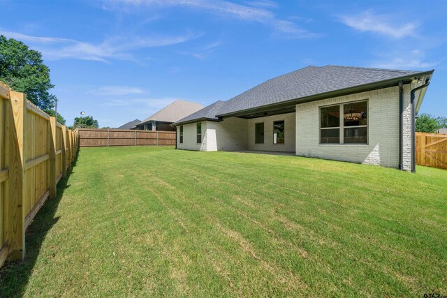 1838 Rocky Mtn, Tyler, TX 75703 - rear view of property featuring brick siding, a fenced backyard, and roof with shingles