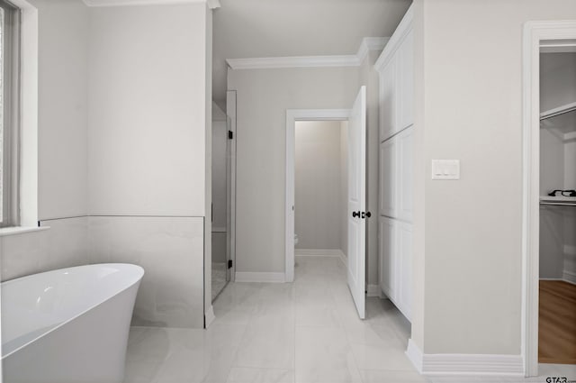 1838 Rocky Mtn, Tyler, TX 75703 - bathroom with a freestanding bath, a walk in closet, ornamental molding, and marble finish flooring