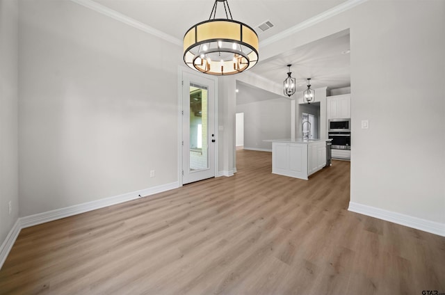 1838 Rocky Mtn, Tyler, TX 75703 - unfurnished dining area featuring a chandelier, ornamental molding, and light wood-style floors