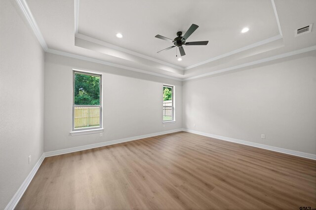 1838 Rocky Mtn, Tyler, TX 75703 - unfurnished room with a raised ceiling, healthy amount of natural light, light wood-type flooring, ornamental molding, and recessed lighting