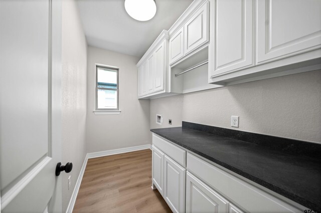 1838 Rocky Mtn, Tyler, TX 75703 - washroom featuring hookup for an electric dryer, washer hookup, light wood-type flooring, and cabinet space