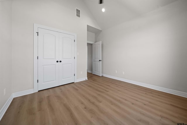 1838 Rocky Mtn, Tyler, TX 75703 - unfurnished bedroom featuring high vaulted ceiling, light wood-style floors, and a closet
