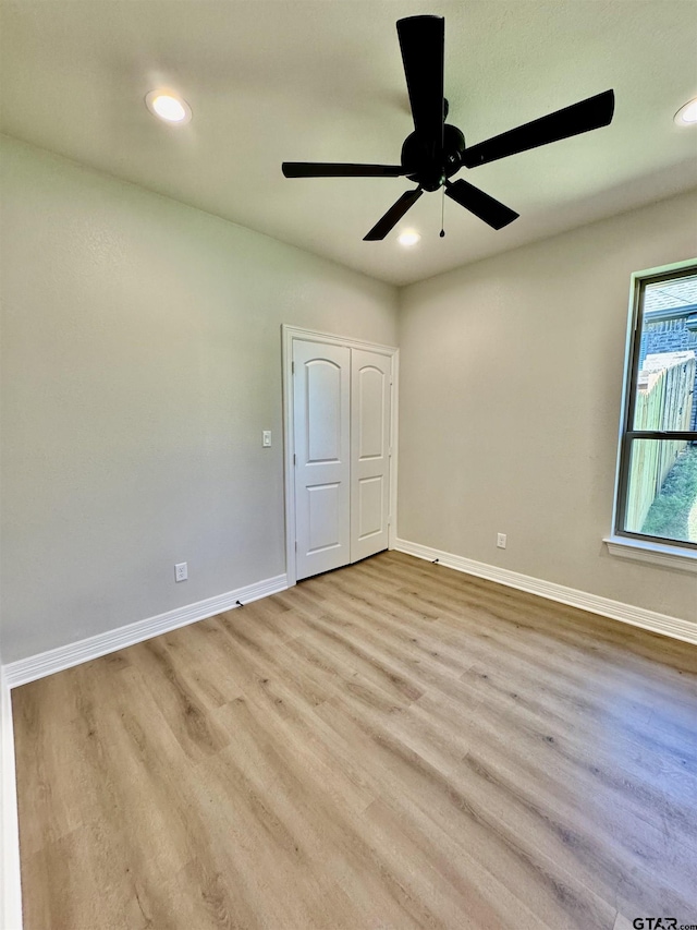 unfurnished bedroom with baseboards, recessed lighting, and wood finished floors