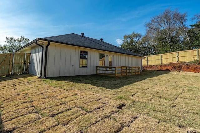 back of house featuring a yard and a wooden deck